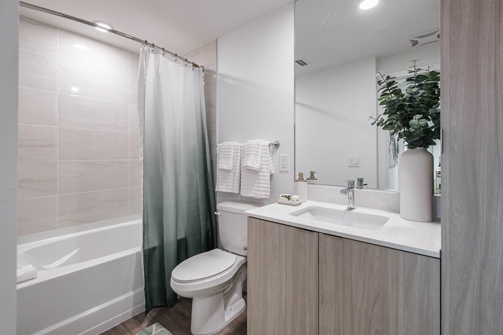 a bathroom with a shower toilet and sink