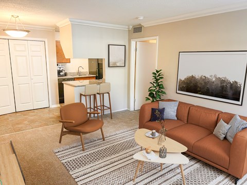 A living room with a brown couch, a brown chair, and a coffee table.