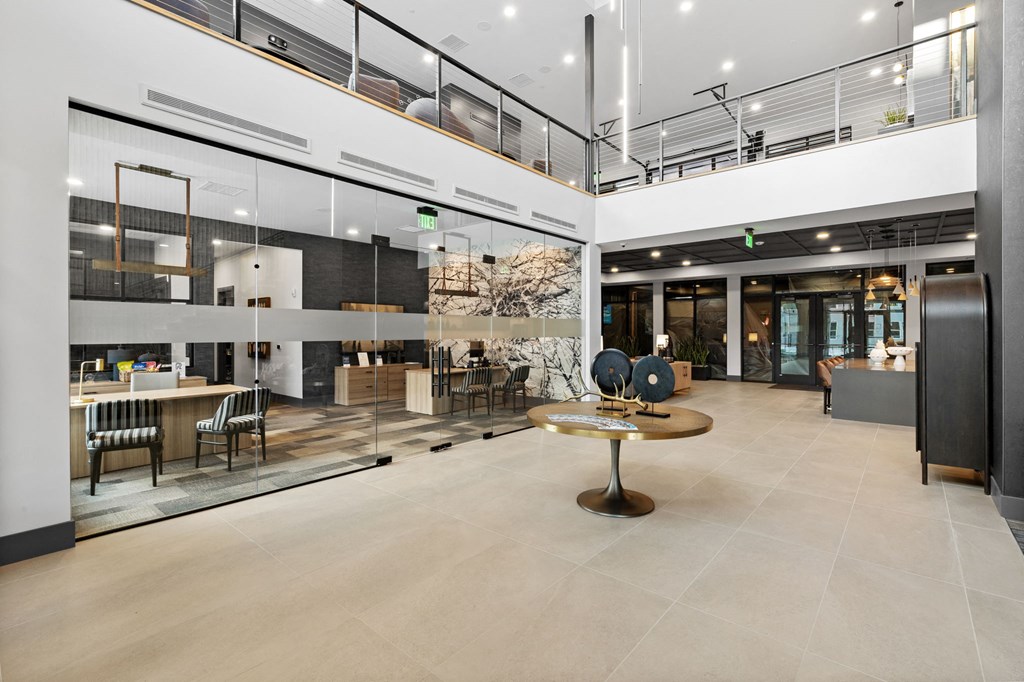 A modern open space with a central table and chairs.