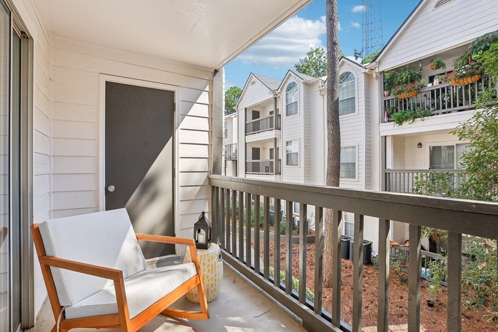A balcony with a chair and table.