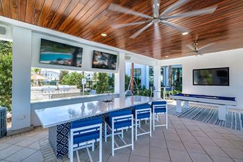 a bar area with a pool table and a television at Altis Twin Lakes Apartments, Florida, 34744