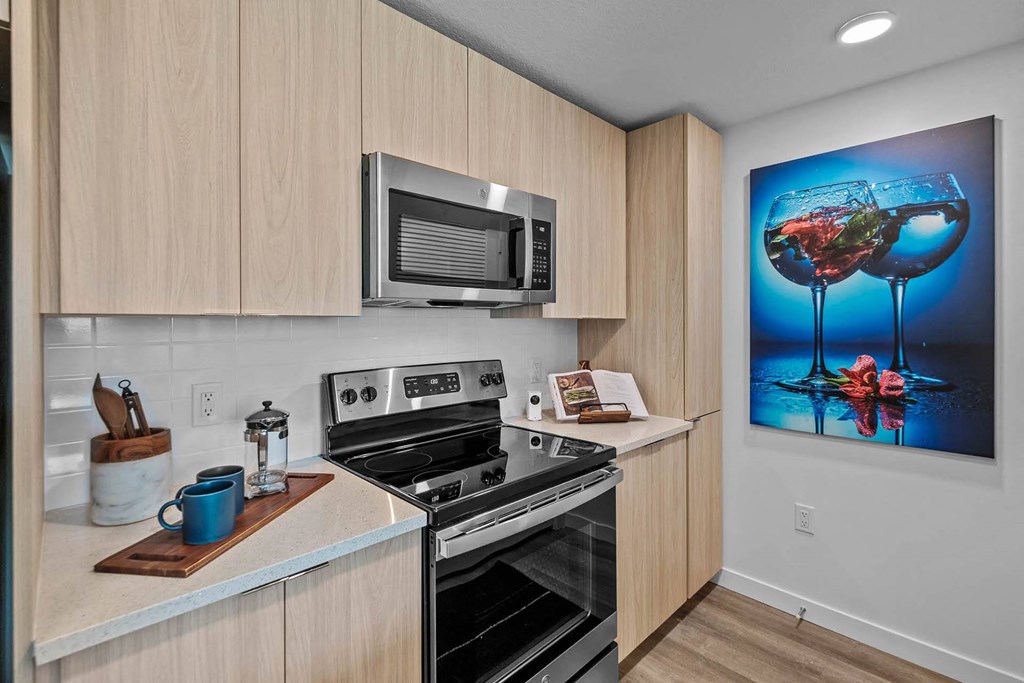 a kitchen with a stove and a microwave at Altis Blue Lake, Lake Worth, FL, 33467