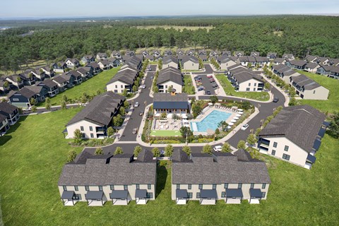 A bird's eye view of a residential area with houses and a swimming pool.