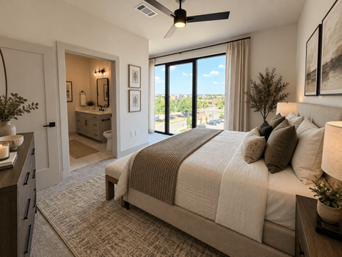 A bedroom with a large bed and a view of the city.