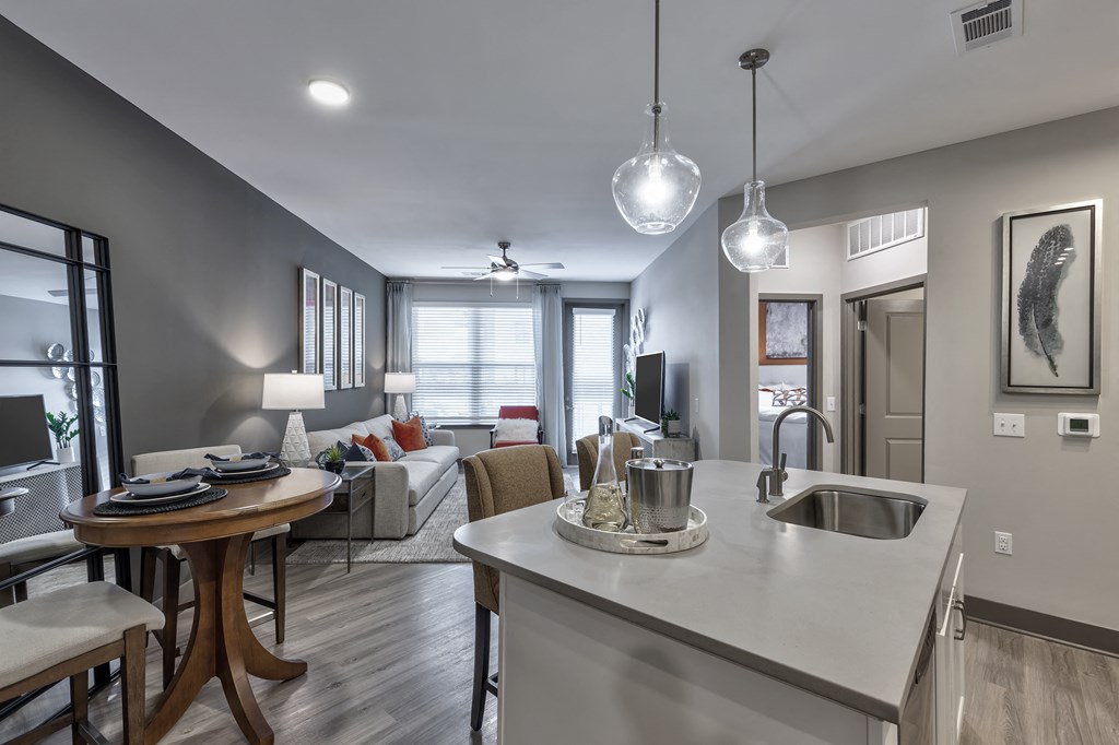 an open kitchen and living room with a couch and a table