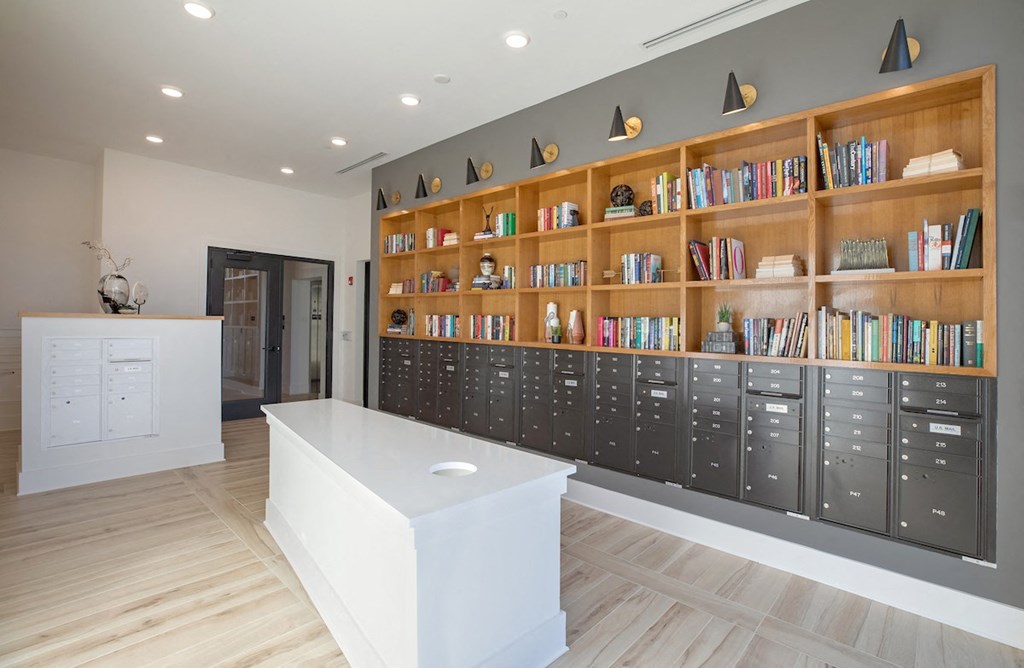 the lobby of a library with a desk and lockers