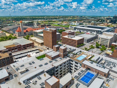 an aerial view of the city of birmingham with a blue pool in the middle of the