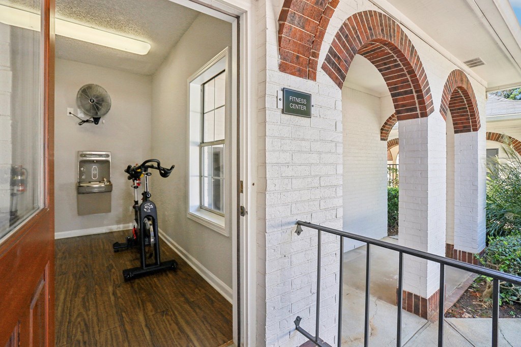 A hallway with a brick archway and a sign that says "ENTRY".