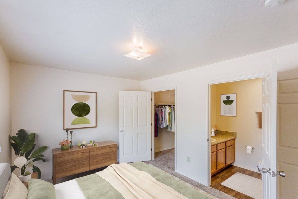 a bedroom with a bed and a bathroom with a closet