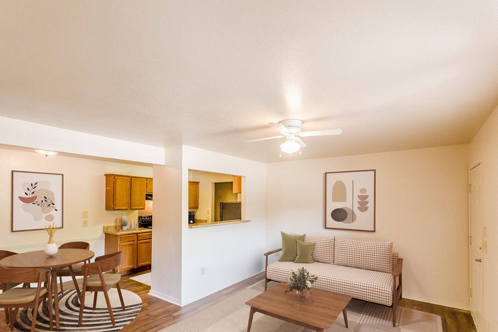 a living room with a couch and a table and a ceiling fan
