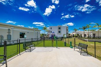 A playground with a slide and a basketball court at Altis Santa Barbara, Florida