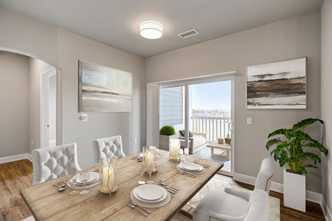 A dining room with a wooden table set for two.