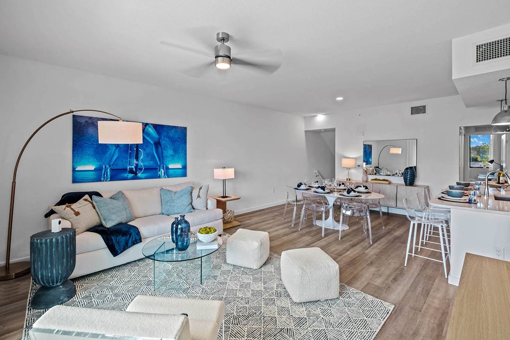 a living room and dining room with a couch and a table at Altis Blue Lake, Lake Worth, 33467