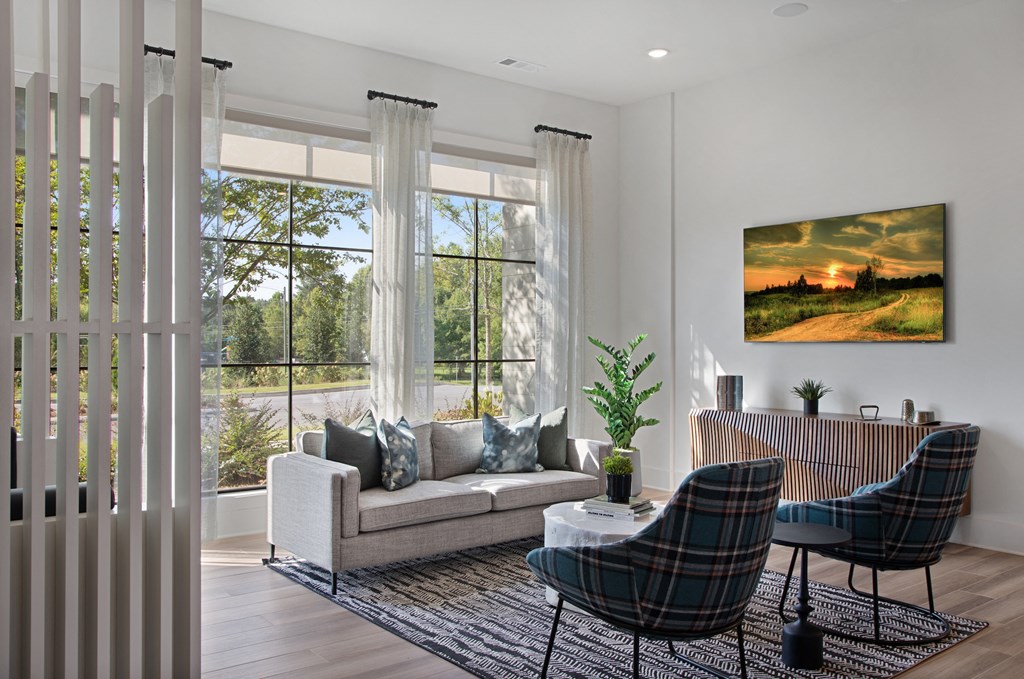 a living room with a couch and two chairs