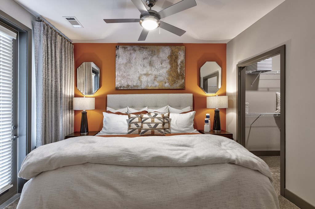 a bedroom with a large bed and a ceiling fan