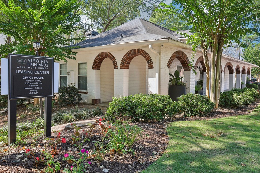 A sign in front of a building that says Virginia Apartment Homes Leasing Center.