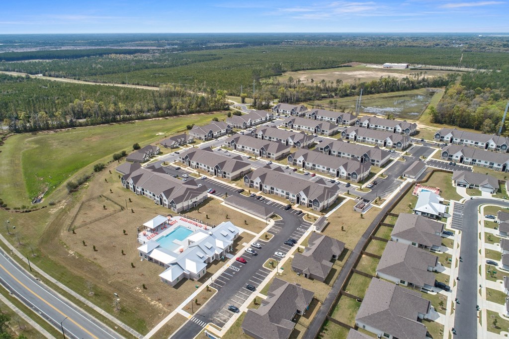 an aerial view of a neighborhood of houses and a parking lot