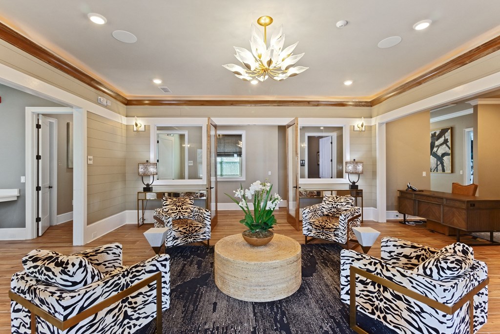a living room with zebra print chairs and a table