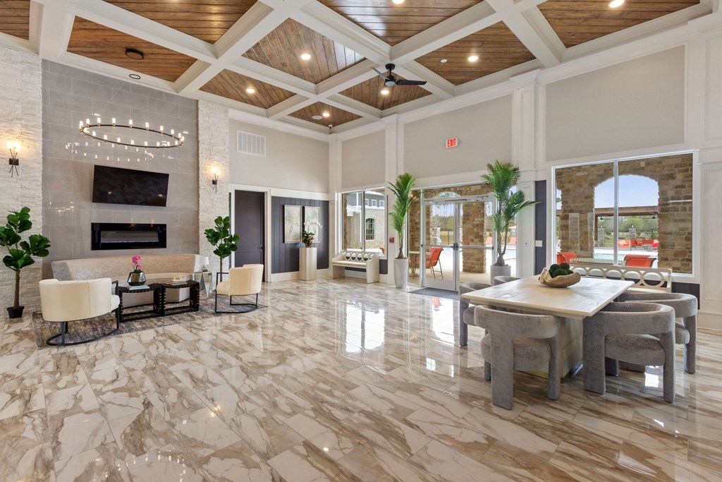 a large living room with a marble floor and a fireplace