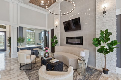 a living room with a couch and chairs and a fireplace