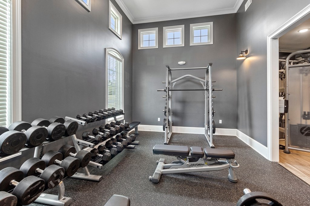 a gym with dumbbells and weights on the floor