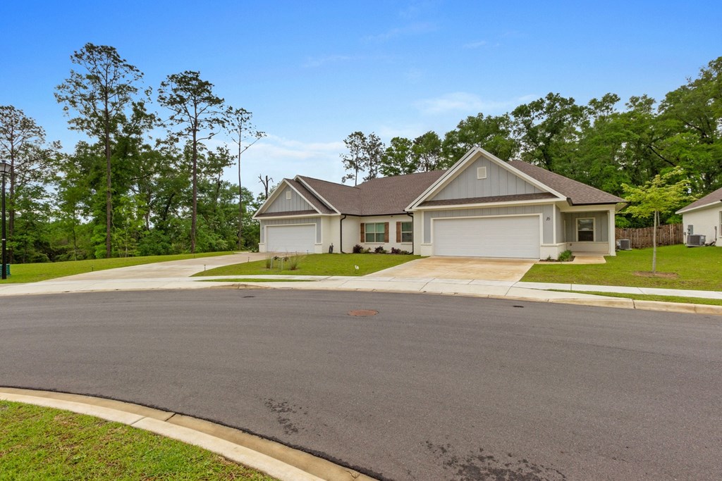 a house with a driveway and a street in front of it