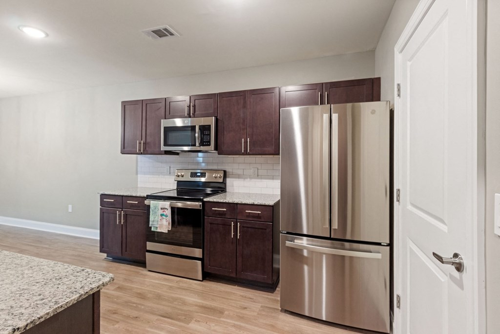 a kitchen with stainless steel appliances and wooden cabinets