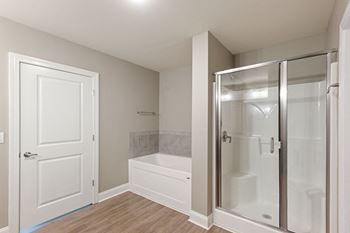 an empty bathroom with a shower and a toilet