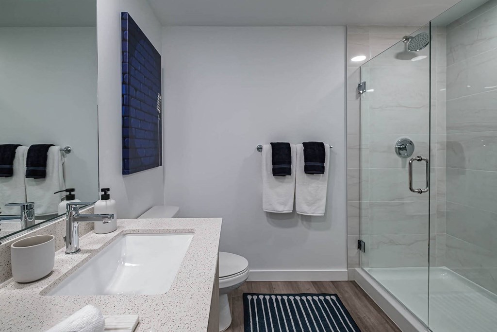 a bathroom with a shower and a sink and a toilet at Altis Blue Lake, Lake Worth, FL, 33467