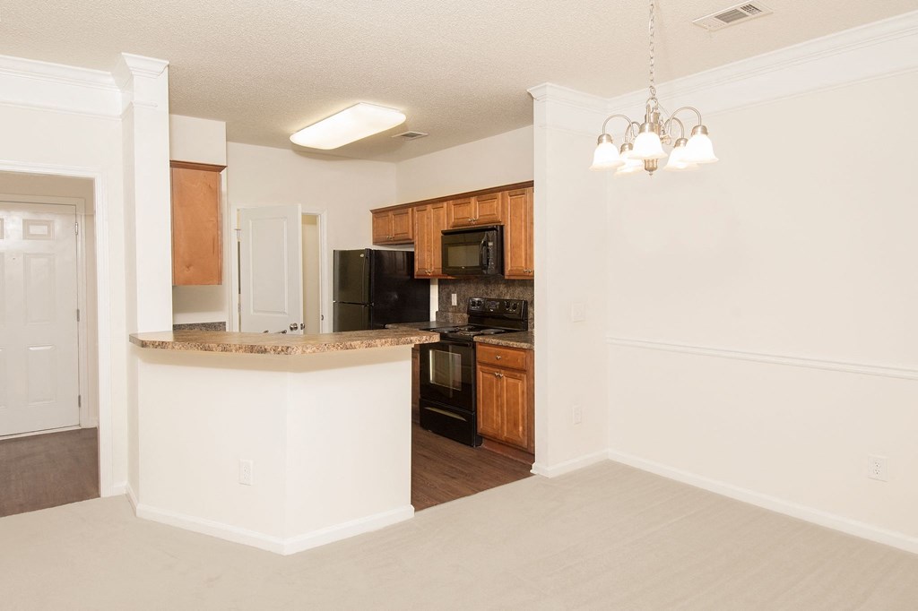 an empty kitchen with an island in the middle of it