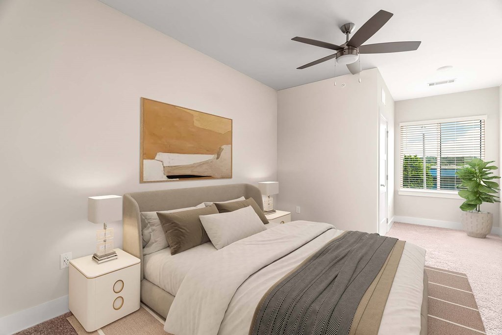 A bedroom with a bed, nightstand, and a ceiling fan.