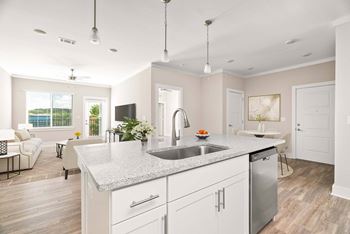 A modern kitchen with a large island and stainless steel appliances.