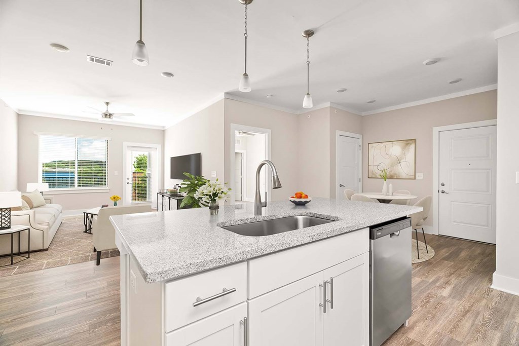 A modern kitchen with a large island and stainless steel appliances.