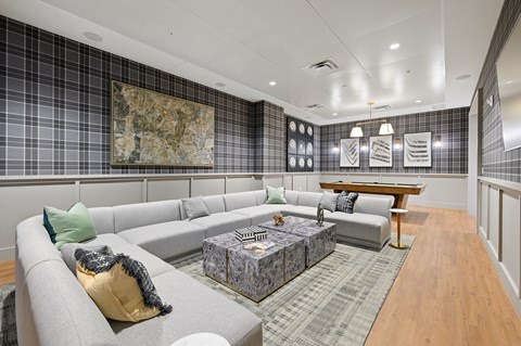 a large living room with couches and a pool table