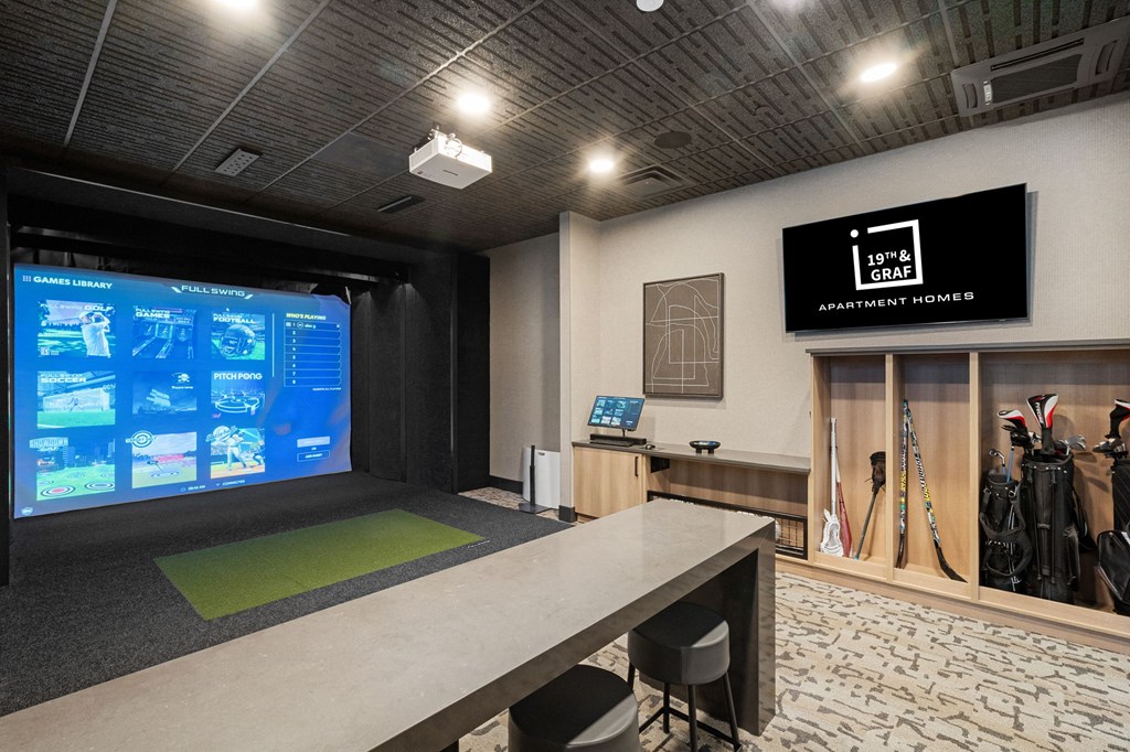 A room with a screen displaying information and a sign that says "Apartment Homes".