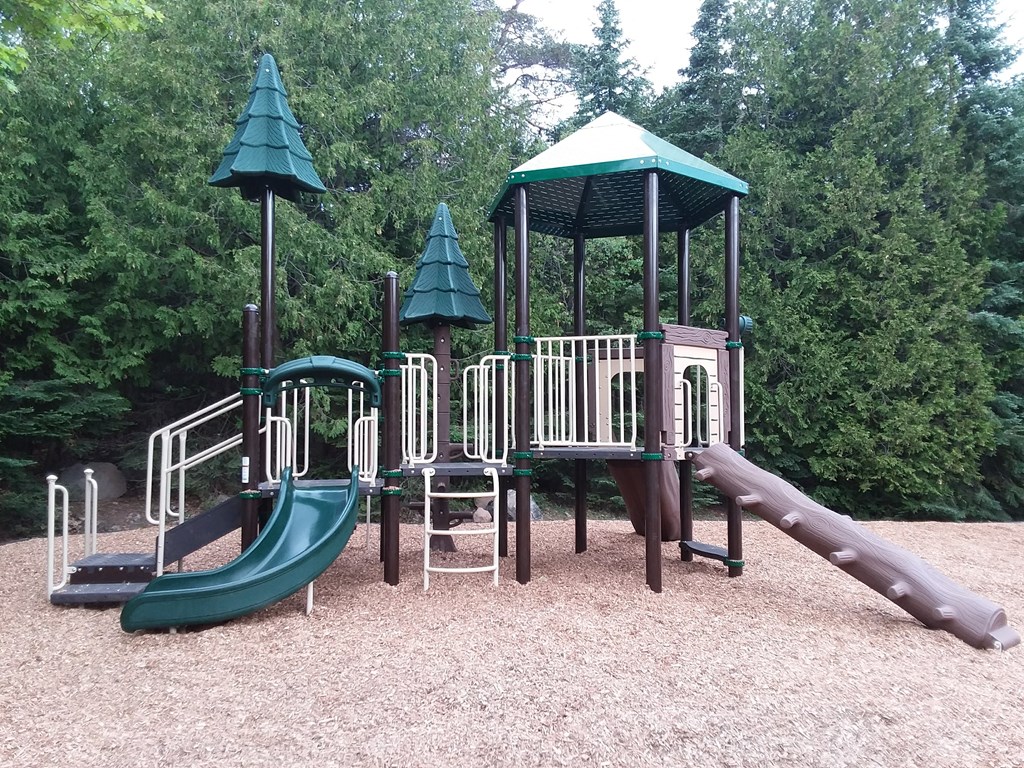 a playground with a slide and swings