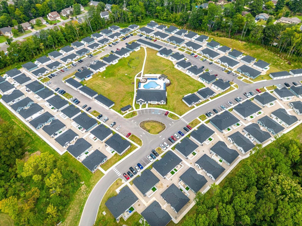 an aerial view of a parking lot with cars and a basketball court