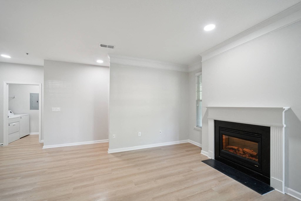 a living room with a fireplace and white walls