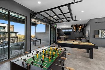 a game room with a foosball table and a pool table