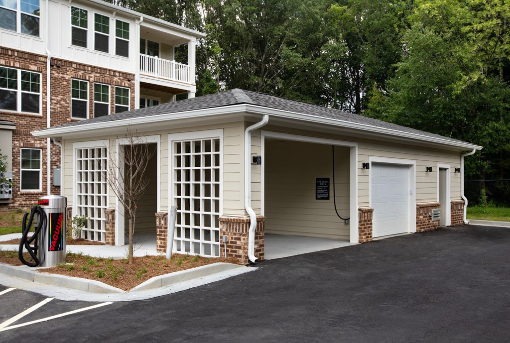 a garage with a white door and a white garage door on the side of a building