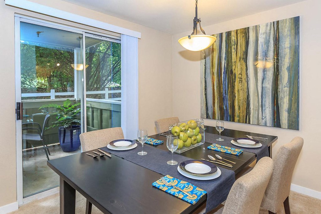 a dining room with a table and chairs