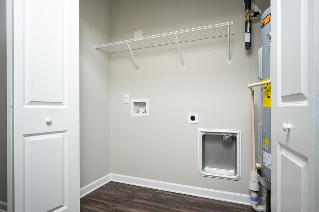 a laundry room with a washing machine and a dryer on the wall