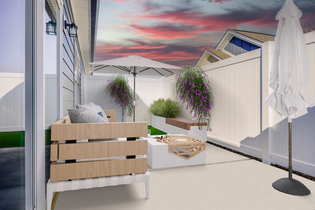 a patio with a bench and a table with an umbrella