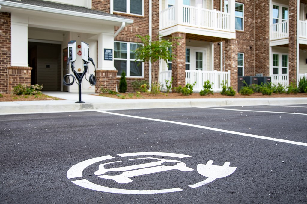 a symbol of a wheelchair in a parking lot in front of a building