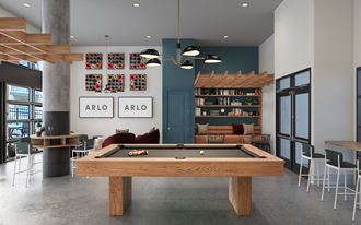 a communal area with a pool table in the middle of it