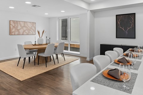 A modern dining room with a large table and chairs.