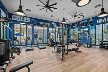 A gym with a variety of equipment and a ceiling fan at Altis Santa Barbara, Florida