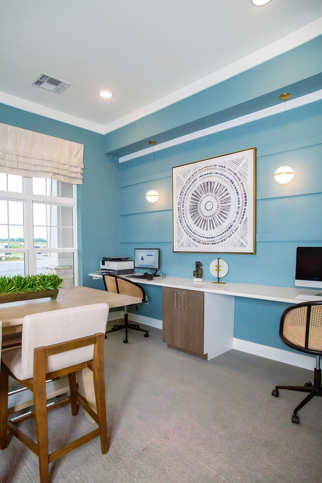 a home office with a desk and chairs and a computer
