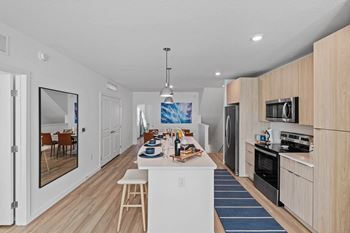 A modern kitchen with a dining area and a bar