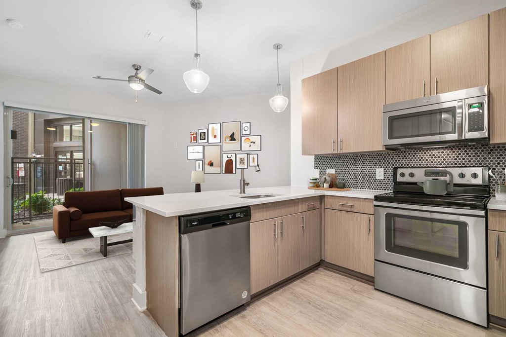 A modern kitchen with a dining area and a balcony.